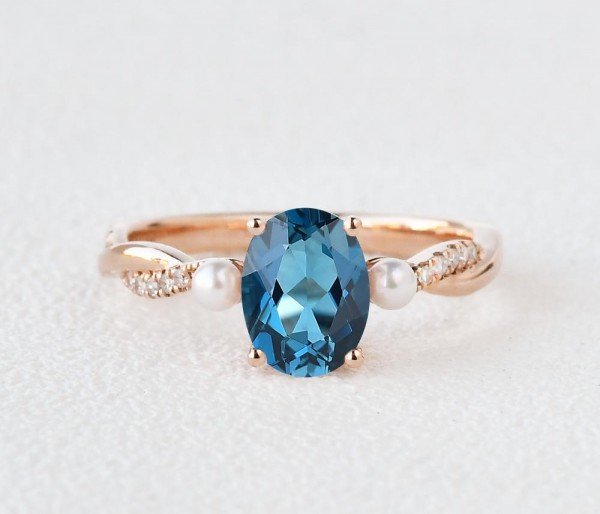 Oval Shaped Blue Topaz Trinity Twist Ring - Rose - Front