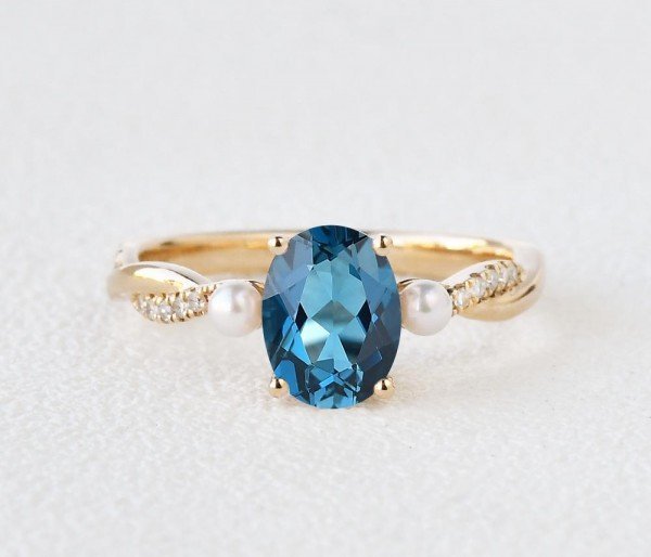 Oval Shaped Blue Topaz Trinity Twist Ring - Yellow - Front